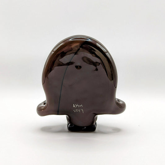 AKM Skull, 2017 Northstar 144 Grizzly Brown Borosilicate Glass Skull Pendant with Opal Eyes Approx. 2.6 x 2.4 in Hand blown glass made by AKM. Signed "AKM" + Dated "2017"