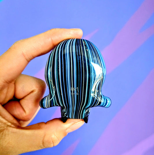 AKM Skull, 2018 Illuminati Sleeved Borosilicate Glass Skull Pendant with Opal Eyes Approx. 2.4 x 2.4 in Hand blown glass made by AKM. Signed "AKM" + Dated "2018"