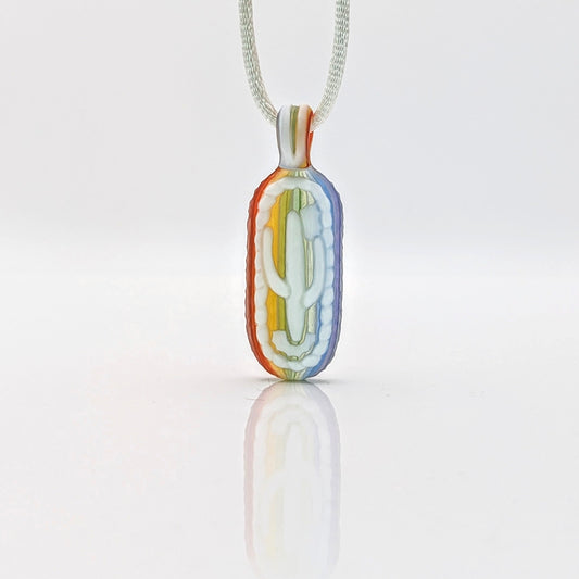 Kellie Thurston Rainbow Cactus (Rainbow Linework under Lotus White), 2024 Borosilicate Glass Pendant 55 mm x 19 mm Hand carved borosilicate glass pendant by Kellie Thurston. Prep by Dan Longden.