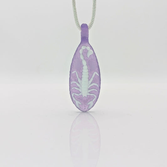 Kellie Thurston Scorpion (Purple Lollipop under Lotus White), 2024 Borosilicate Glass Pendant 66 mm x 26 mm Hand carved borosilicate glass pendant by Kellie Thurston. Prep by Dan Longden.