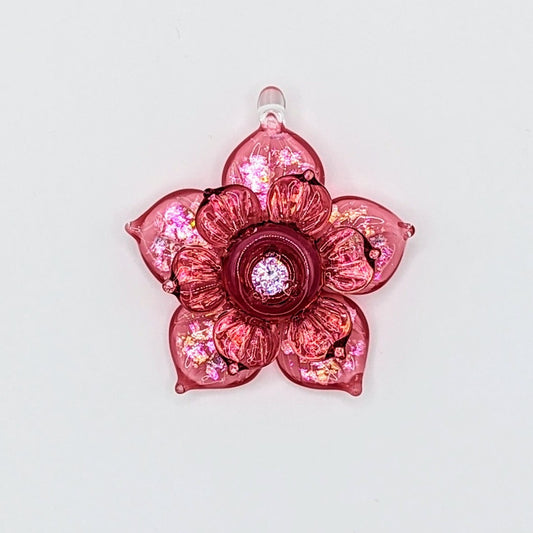 Mars Pink Sparkly Spinning Flower, 2024 Borosilicate Glass Pendant Approx. 40 mm Hand blown & cold worked borosilicate glass pendant featuring transparent pink and Cubic Zirconia center made by Mars.