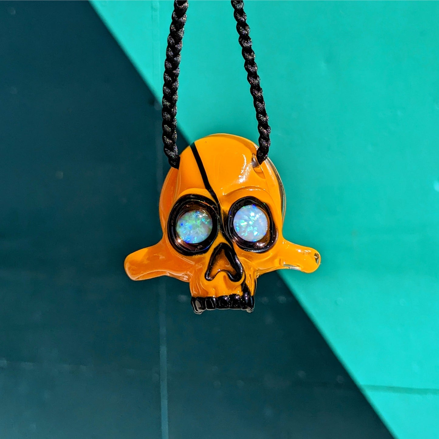 AKM Skull, 2015 Northstar 84 Goldenrod Borosilicate Glass Skull Pendant with Opal Eyes Approx. 2.4 x 2.4 in Hand blown glass made by AKM. Signed "NS-84 AKM" + Dated "2015"