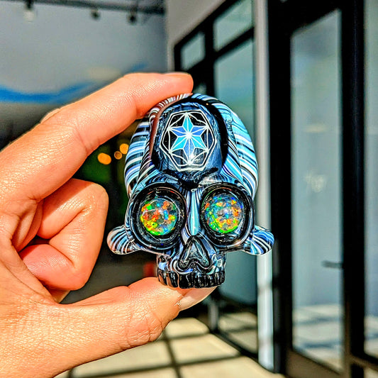 AKM x Akio Skull, 2018 Borosilicate Glass Pendant with Opal Eyes Approx. 2.4 x 2.4 in  Hand blown glass made by AKM and Akio. Signed "AKM" + Dated "2018"