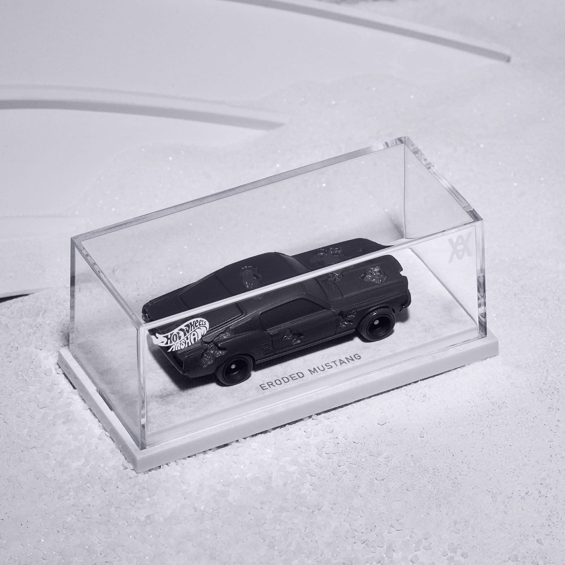 Daniel Arsham x Hot Wheels Ford Mustang, 2024  Features: Crystallized erosions Body Color: Arsham Black Body Type: Silkstone Chassis: ZAMAC Wheels: Real Riders 5-spoke mag wheels  Scale 1:64 Includes sealing label and Certificate of Authenticity Packaged in a collector display case 