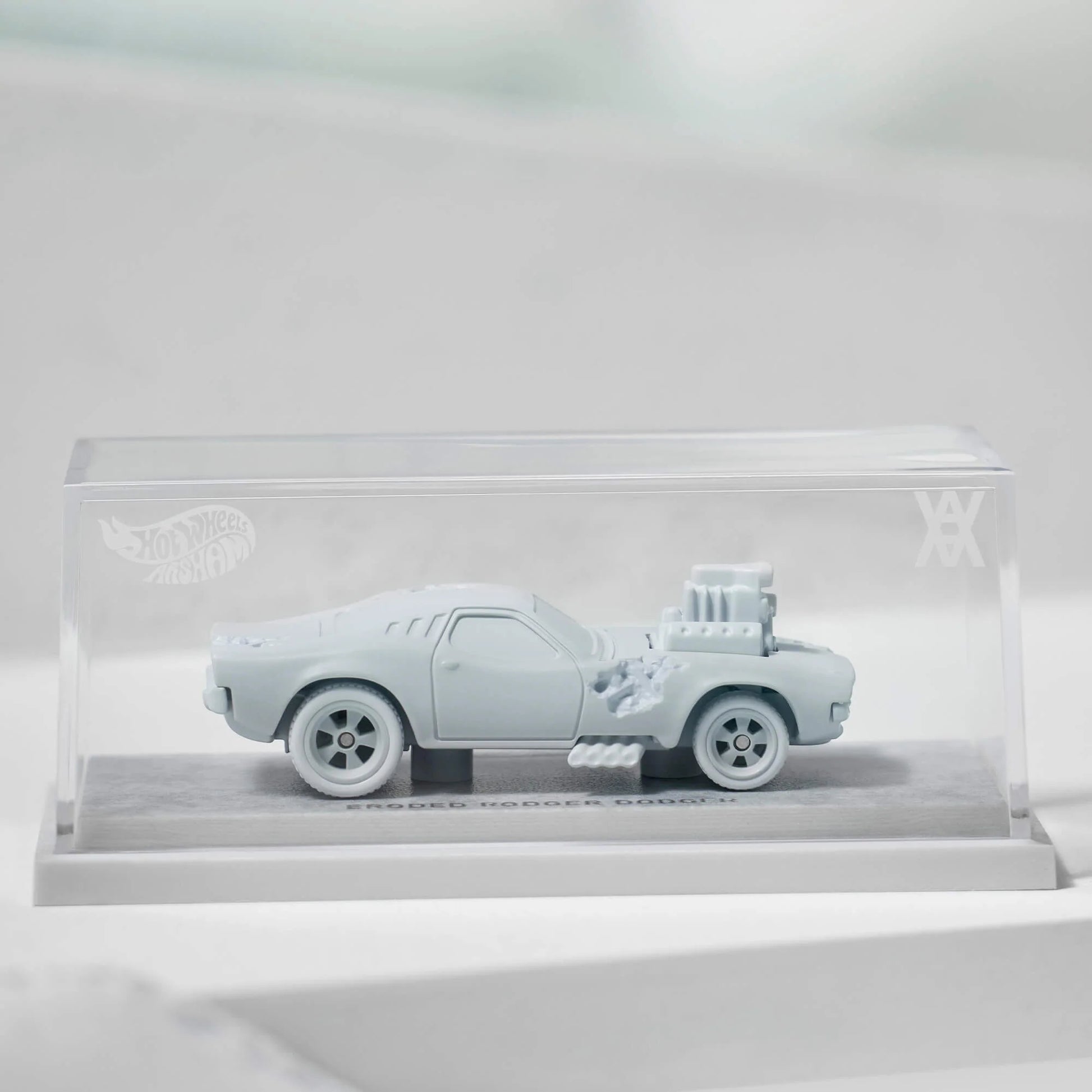 Daniel Arsham x Hot Wheels Eroded Rodger Dodger, 2023 Features: Sculpted crystallized erosions Body Color: Arsham Blue Body Type: Silkstone Chassis: ZAMAC Interior: ZAMAC Wheels: Real Riders wheels Scale 1:64 Includes sealing label and Certificate of Authenticity Packaged in a collector display case with simulated concrete base.