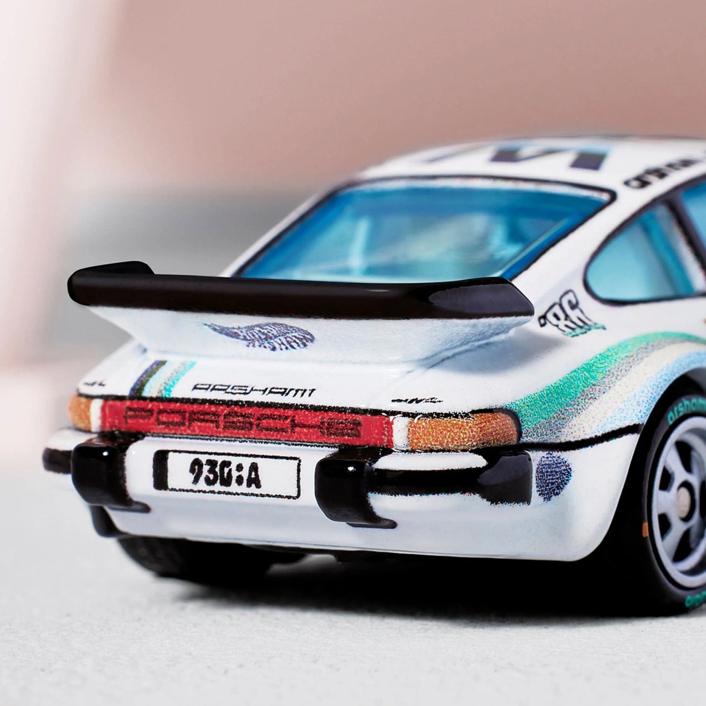 Daniel Arsham x Hot Wheels Livery Porsche 930A, 2024 Body Color: Gloss white Body Type: ZAMAC Chassis: ZAMAC Wheels: Real Riders classic 5-spoke wheels with liquid silver hubs and “arsham studio” tampo Window Color: Lightly tinted Interior Color: Plastic replica of 1:1 version’s Italian leather and stonewashed canvas Scale 1:64 Includes sealing label and Certificate of Authenticity Packaged in a collector display case with simulated concrete base.