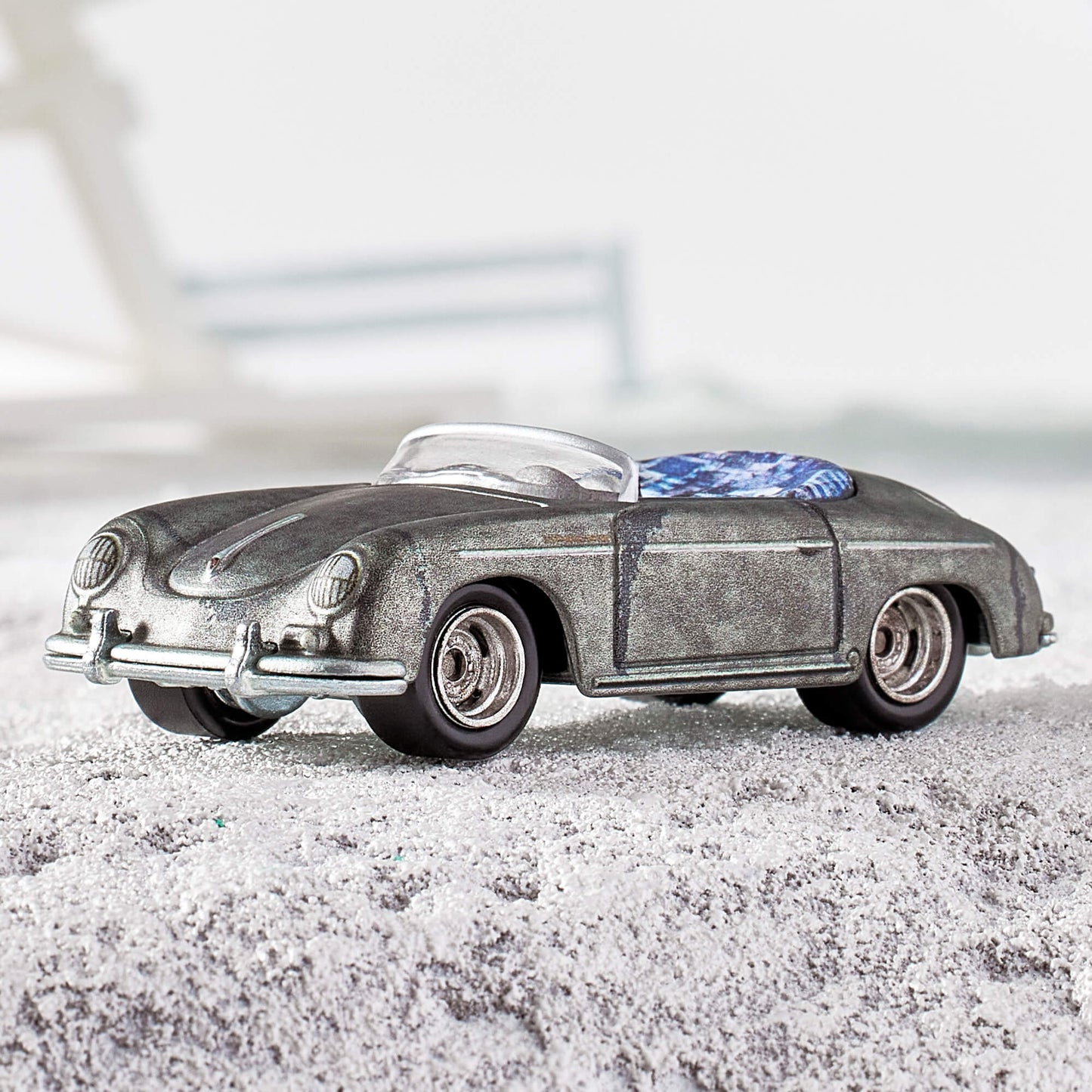 Daniel Arsham x Hot Wheels Porsche 356 “Bonsai” Speedster, 2023 Features: Sculpted crystallized erosions Body Color: Weathering effect to match ZAMAC color Body Type: ZAMAC Chassis: ZAMAC Wheels: Real Riders deep dish wheels with wash/wipe weathering effect Window Color: Clear Interior Color: Plastic replica of 1:1 version’s indigo-dyed Japanese textiles Scale 1:64 Includes sealing label and Certificate of Authenticity Packaged in a collector display case with simulated concrete base.