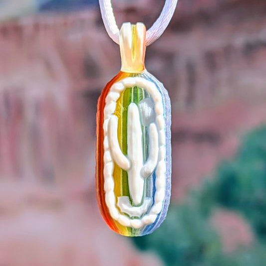 Kellie Thurston Rainbow Cactus (Rainbow Linework under Lotus White), 2024 Borosilicate Glass Pendant 55 mm x 19 mm  Hand carved borosilicate glass pendant by Kellie Thurston. Prep by Dan Longden. 
