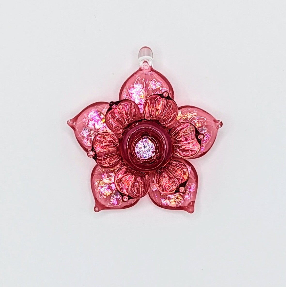 Mars Pink Sparkly Spinning Flower, 2024 Borosilicate Glass Pendant Approx. 40 mm  Hand blown & cold worked borosilicate glass pendant featuring transparent pink and Cubic Zirconia center made by Mars.