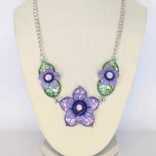 Mars Sparkly Purple and Green Floral Linked Choker Chain, 2024 Borosilicate Glass Necklace With Silver Plated Chain Approx. 37 mm x 20 mm Hand blown borosilicate glass choker necklace featuring opal centers made by Mars.