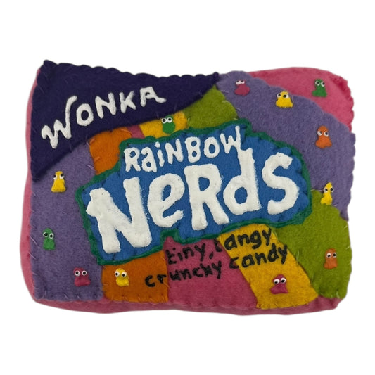 Lucy Sparrow
Rainbow Nerds, 2025
Felt and acrylic paint
Approx. 2 x 4 x 6 in

Handmade felt soft sculpture painted by Lucy Sparrow. Hand signed on verso.