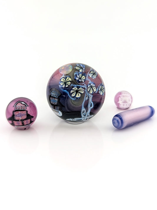 Piper Dan
Asanoha Castle Scene, 2021
UV Reactive Borosilicate Glass Marble Set
21 mm

Hand blown glass made by Piper Dan (Daniel Benway). Set includes 24.8 mm marble (mib), 2 pearls, 1 pillar & 1 valve. Signed "DB" + Dated "2021"