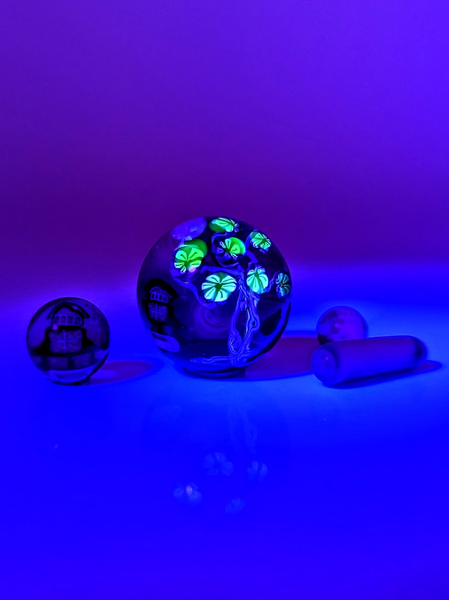 Piper Dan
Asanoha Castle Scene, 2021
UV Reactive Borosilicate Glass Marble Set
21 mm

Hand blown glass made by Piper Dan (Daniel Benway). Set includes 24.8 mm marble (mib), 2 pearls, 1 pillar & 1 valve. Signed "DB" + Dated "2021"