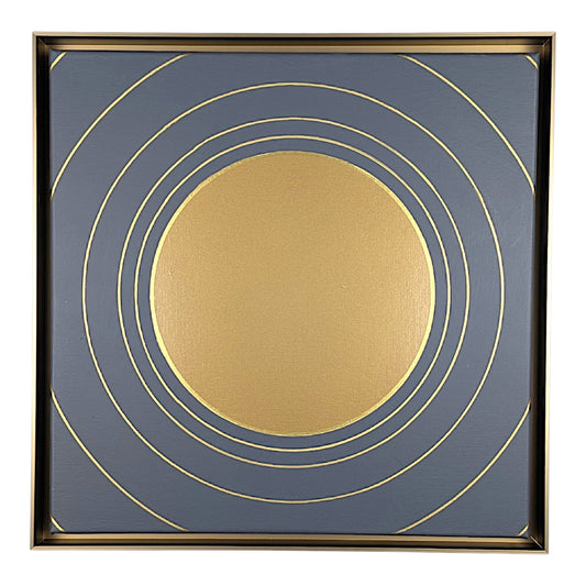 Square framed wall art featuring a minimalist gold circular design on a slate blue background, enclosed in a thin gold frame.