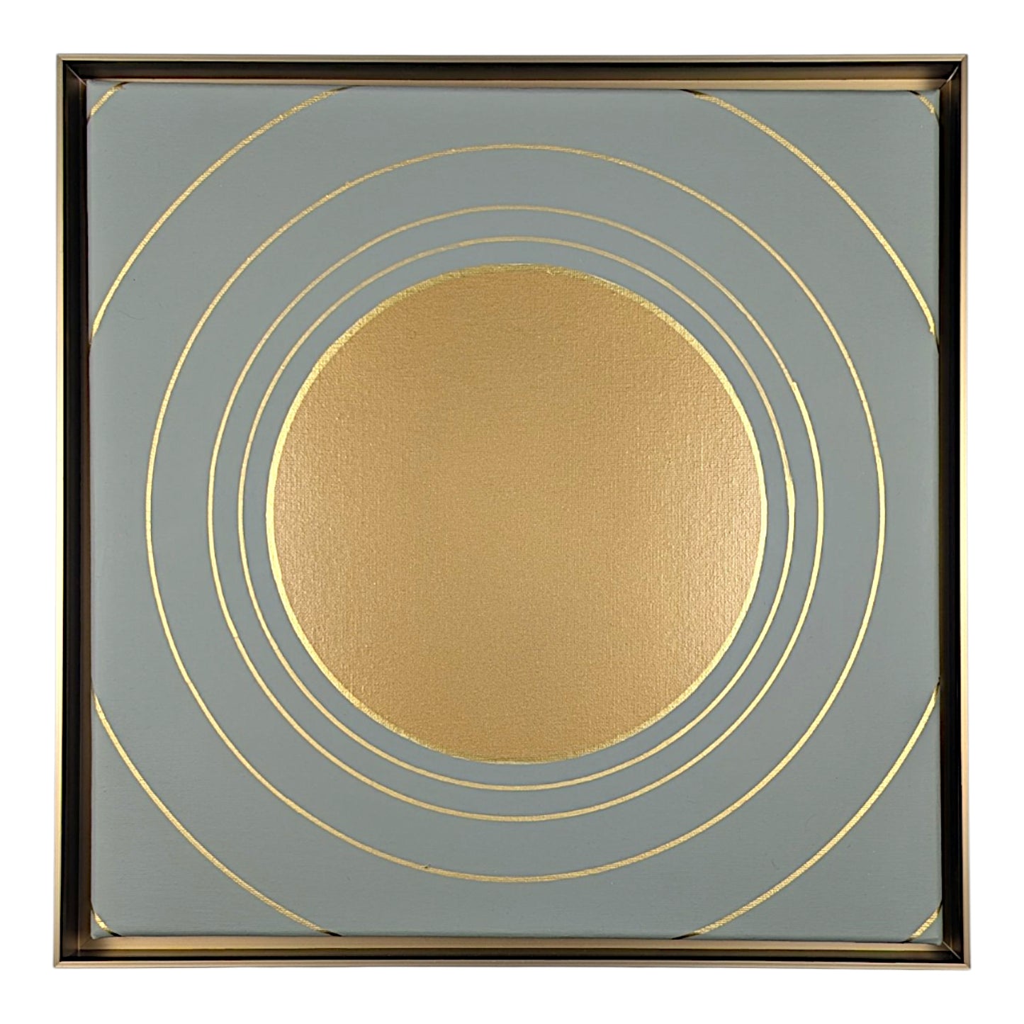 Square abstract wall art featuring a textured metallic gold circle centered within a square field of muted blue-gray, accented by thin gold concentric rings and a thin dark metallic border.