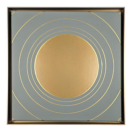 Square abstract wall art featuring a textured metallic gold circle centered within a square field of muted blue-gray, accented by thin gold concentric rings and a thin dark metallic border.