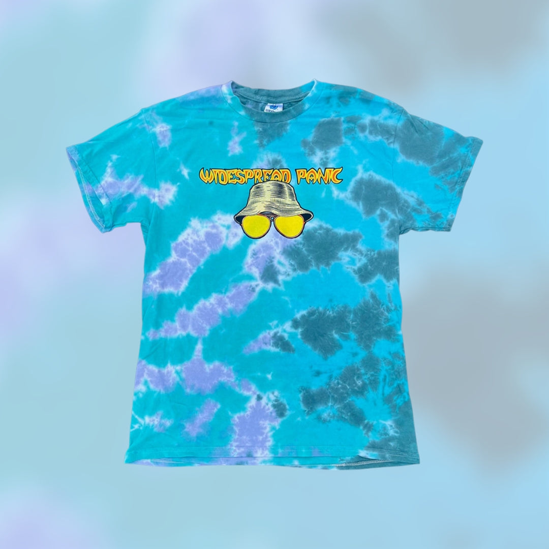 Todd Slater Widespread Panic Vegas 2026 "Fear & Loathing" Tie Dye Shirt 

- Printed on a Colortone T Shirt by Ruby Sue Graphics 
- 100% cotton 
- Pre-shrunk 
- Classic fit 
- Ribbed collar 
- Shoulder-to-shoulder taping 
- Double-needle sleeves and bottom hem 
- Sewn in label 

*Please note there may be slight variations in color and fit (up to 1–2 inches) due to the custom dye process. Wash separately and enjoy the uniqueness of your garment!